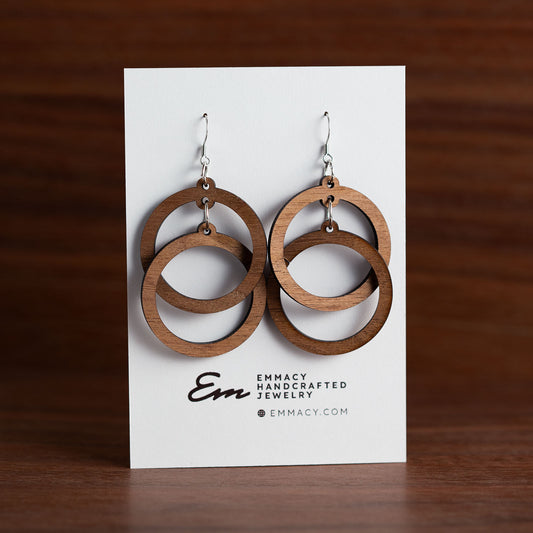 Laser cut wooden earrings in the shape of two circles that are intertwined.